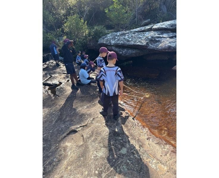 BLSPS Students standing on rock looking at the water